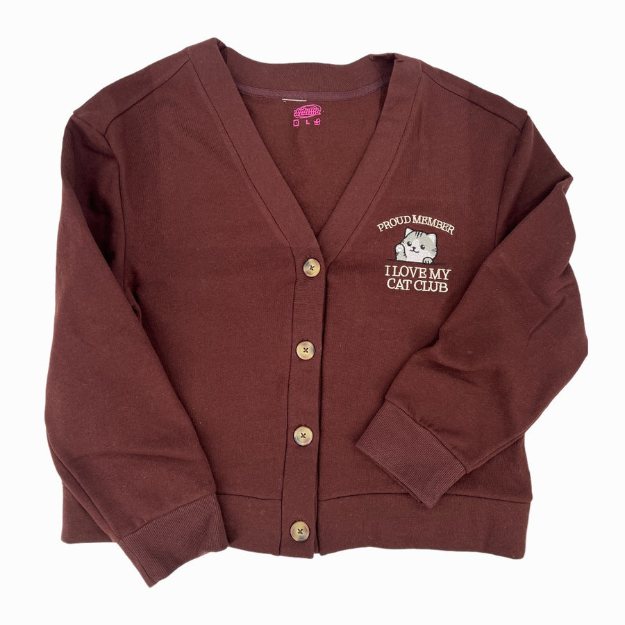 a maroon cardigan sweater with a white dog on it
