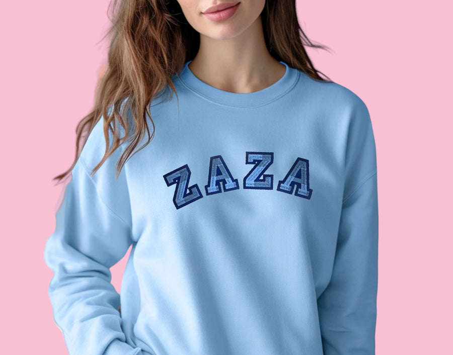 a woman wearing a blue sweatshirt with the letters az on it
