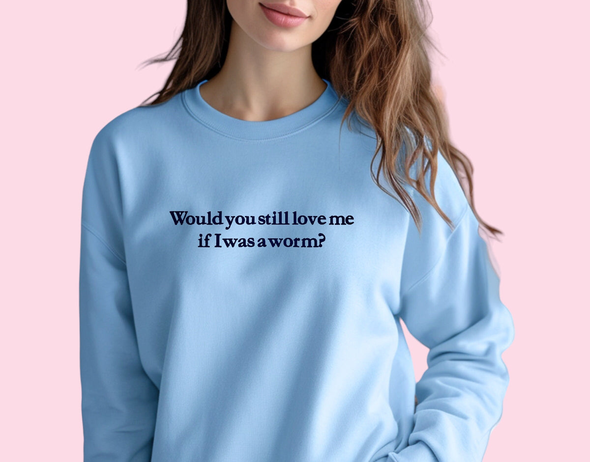 a woman wearing a blue sweatshirt that says would you still love me if i was