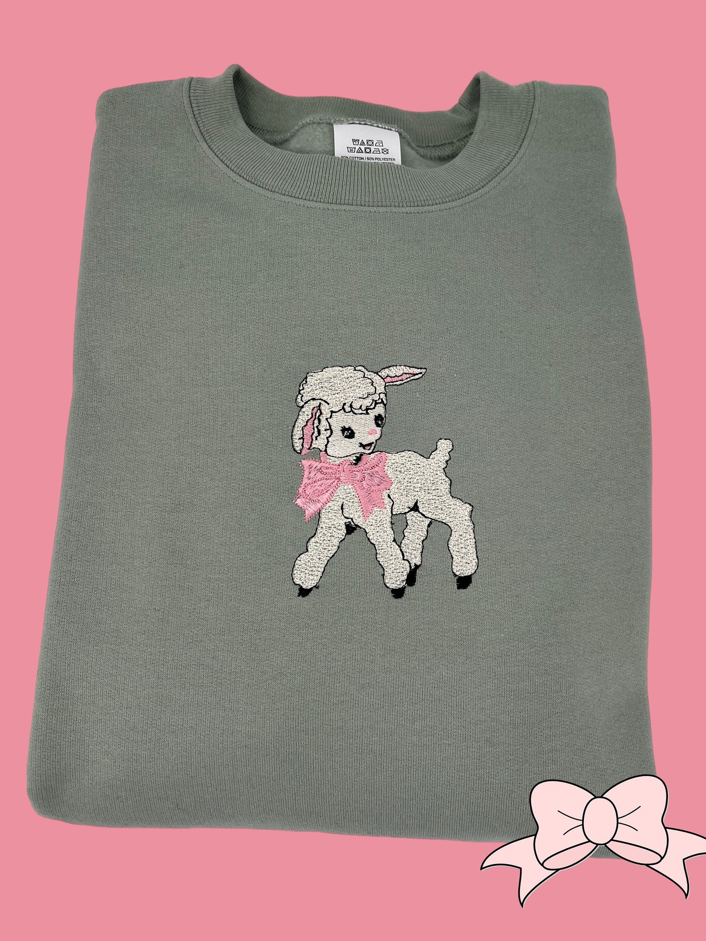 a gray shirt with a pink bow on it